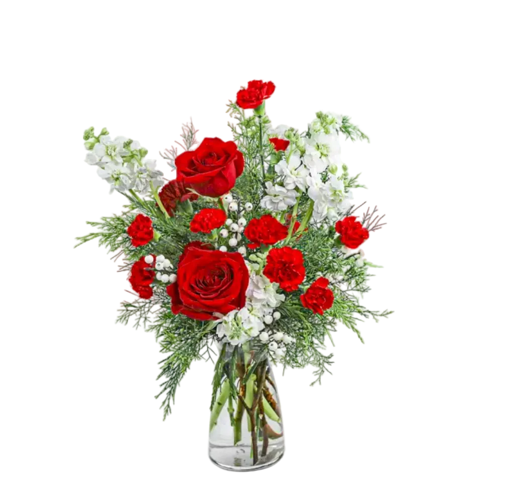 Bouquet of red roses and white flowers in a clear vase on a white background
